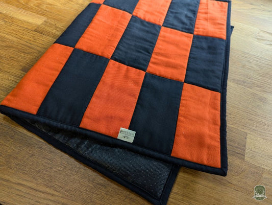 Top down view of orange and black rectangles in an alternating pattern.