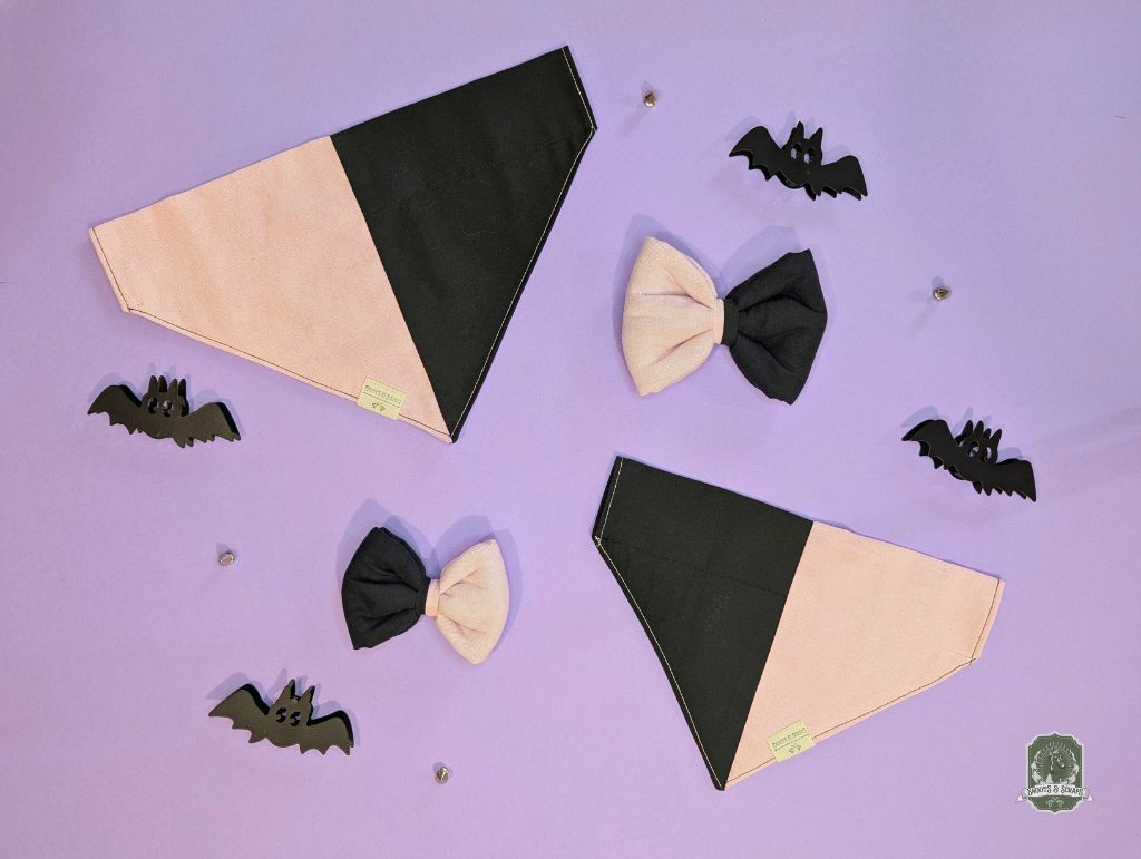 Halloween-themed dog bandanas and pet bow ties on a purple background with decorative bats.