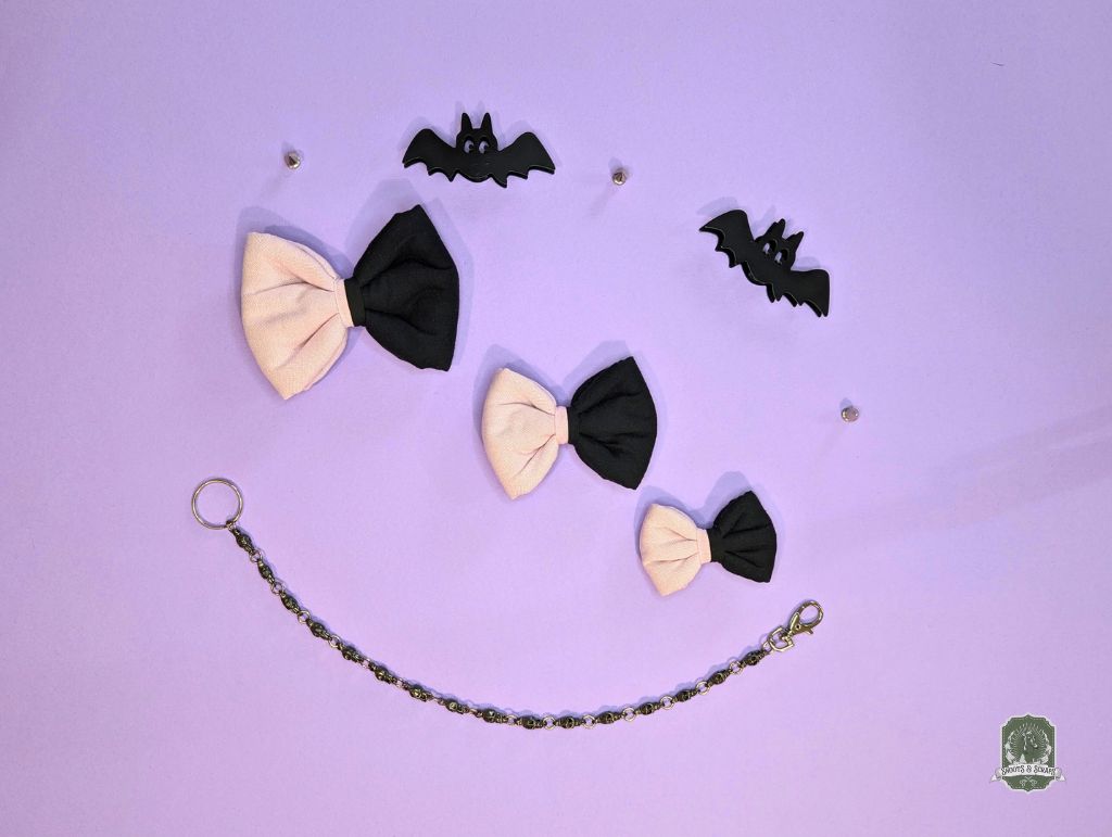 Pet Bow ties and decorative bat shapes on a purple background