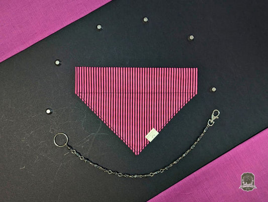 Pink and black striped dog bandana with a decorative chain on a black and pink background