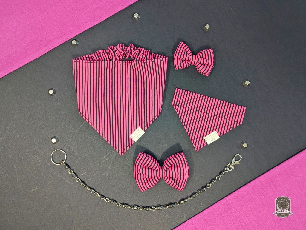Pink and black striped bow tie set on a gray and pink background