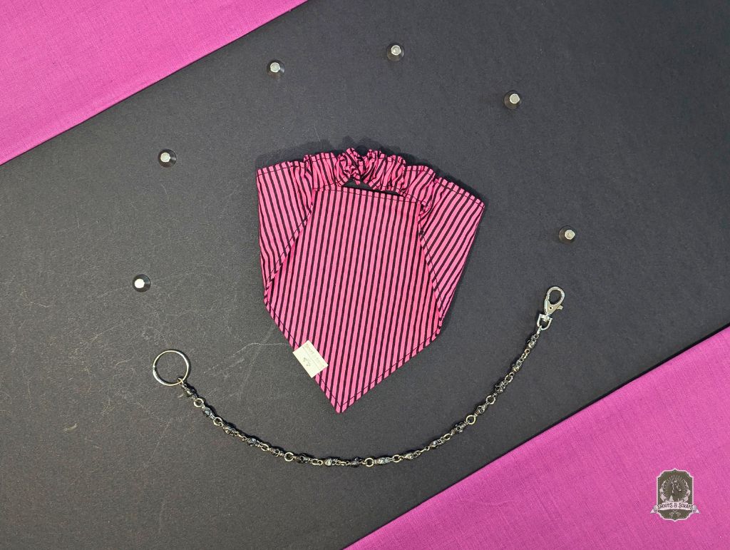 Pink and black striped dog bandana with elasticated collar, with chain on a black and pink background