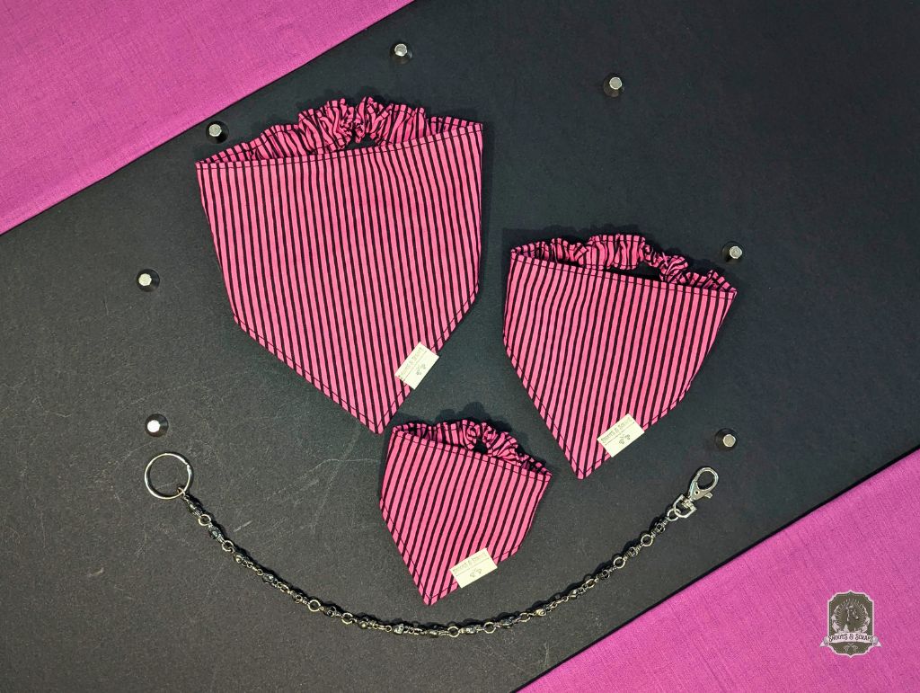 Pink and black striped dog bandanas with elasticated collar, with chain on a black and pink background