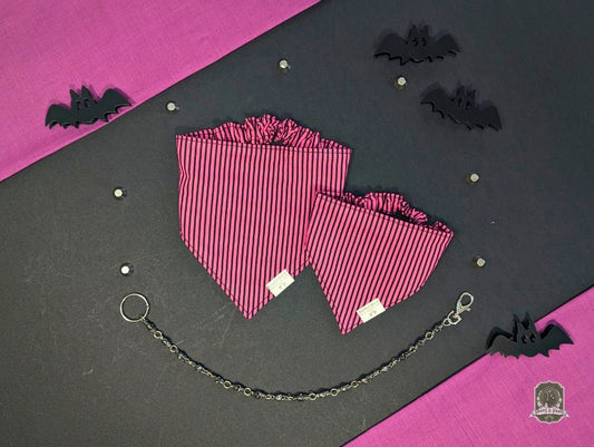 Pink striped elastic dog bandanas with a chain on a black and pink background with bat decorations