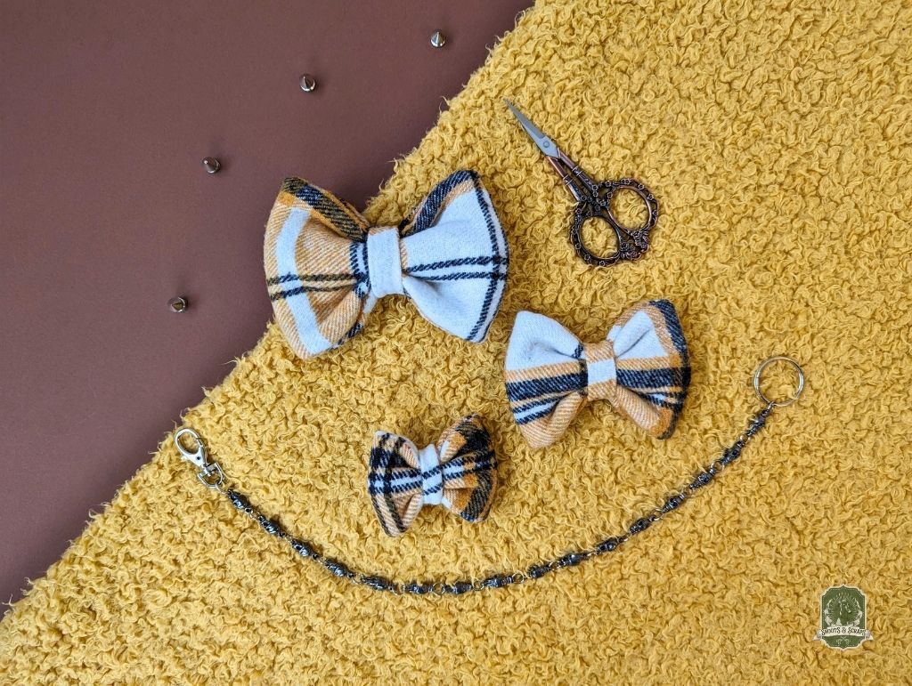 selection of yellow bowties in different sizes, from top to bottom sizes are large, medium and small.