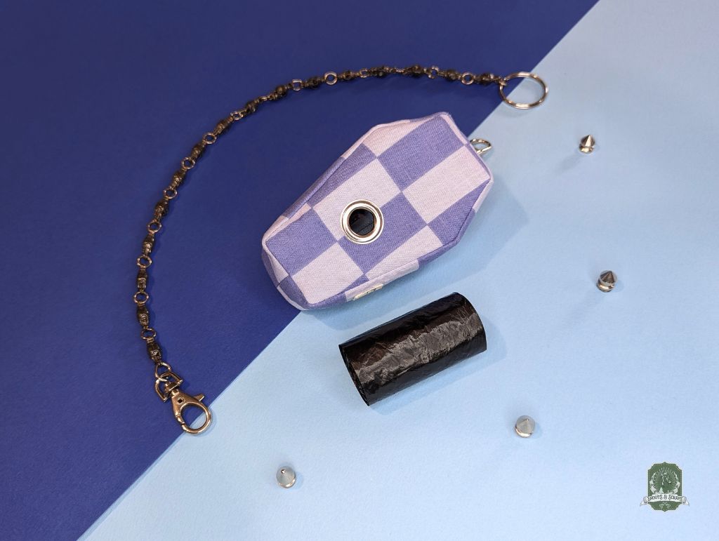 Blue and light blue checkered dog walking pouch with chain on a blue and light blue gradient background