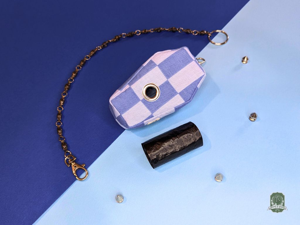 Blue and light blue checkered dog walking pouch with chain on a blue and light blue gradient background