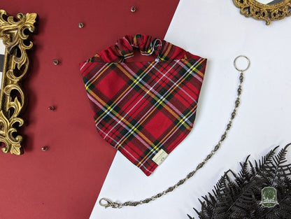 Red plaid dog bandana with a chain on a red and white background
