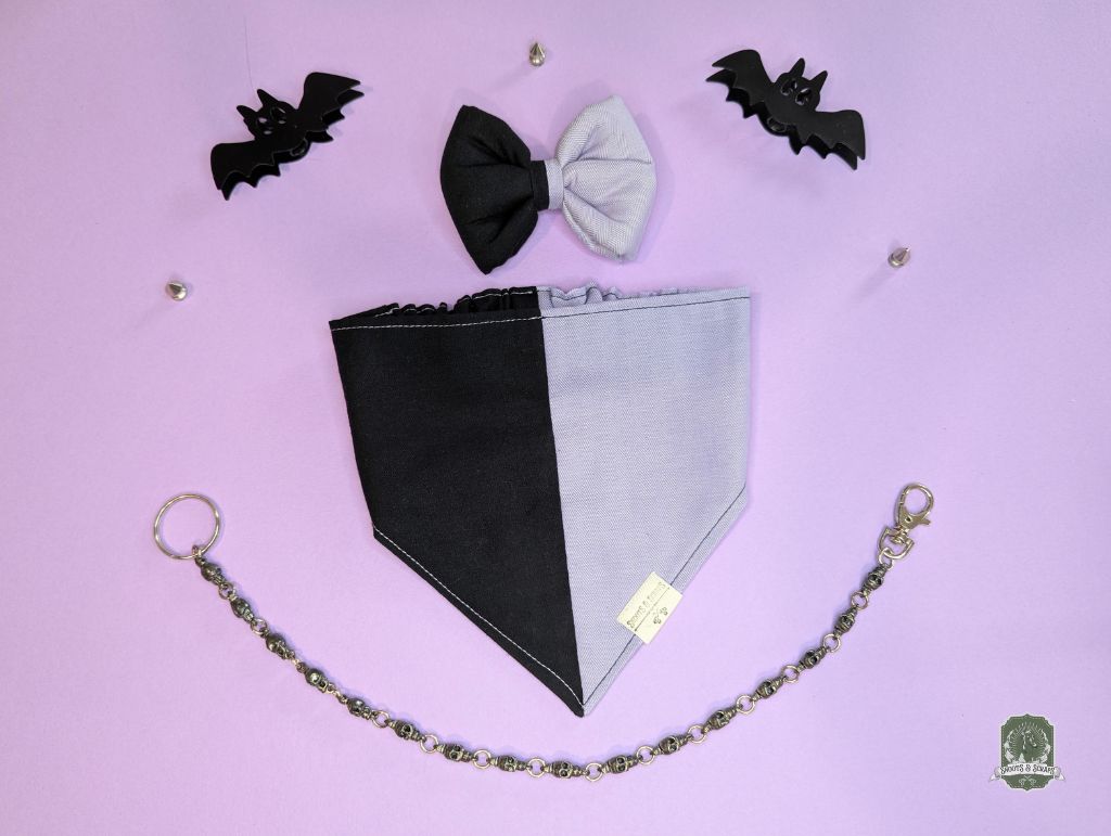Black and lilac dog bandana with matching pet bow tie, decorative bats on a pink background