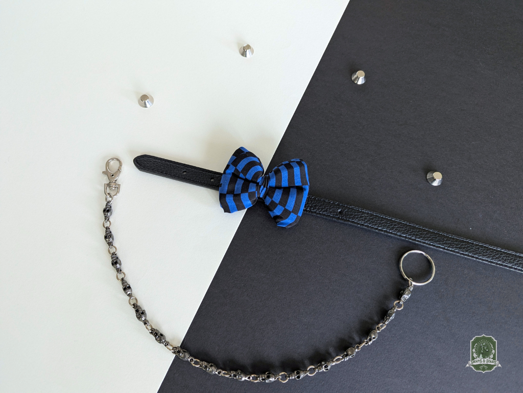 Blue and black Checkerboard pet bow tie on a black leather collar