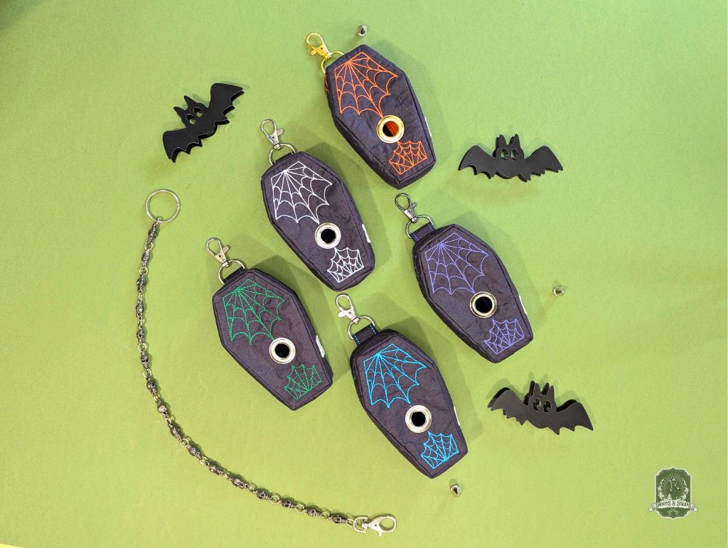 Halloween-themed dog poop bag holders and dispensers with coffin-shape designs on a green background