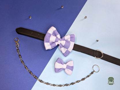 Pastel blue and light blue checkered dog bow tie with a  decorative chain on a blue and purple gradient background