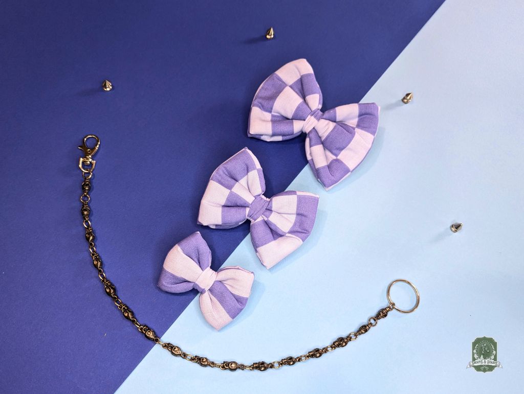 Set of 3 Pastel blue and light blue checkered dog bow ties with decorative chain on a blue and two-tone background