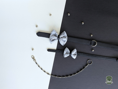 Grey skulls pattern dog and cat bow ties displayed on black leather collars