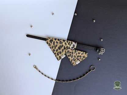 Leopard print pet bandanas displayed on a black collar on a two-tone background