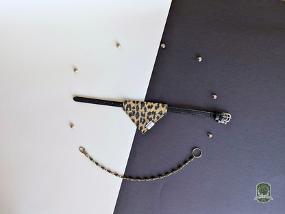 Leopard print pet bandana styled on a black collar on a black and white background