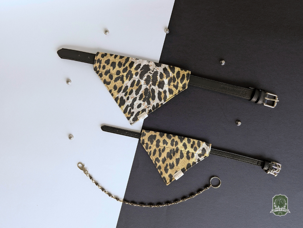 Leopard print pet bandanas styled on a black collar on a black and white background