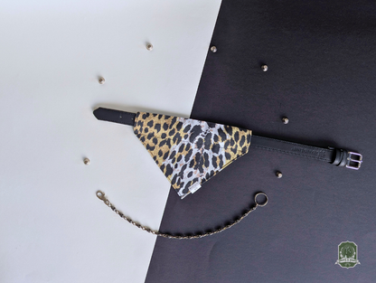 Leopard print pet bandana styled on a black collar on a black and white background