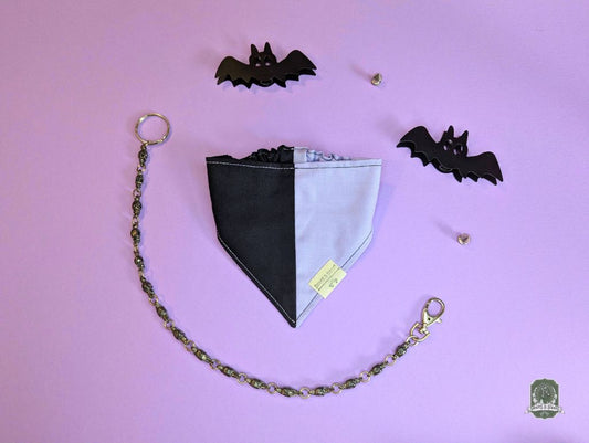 Black and lilac dog bandana with elastic collar on a purple background
