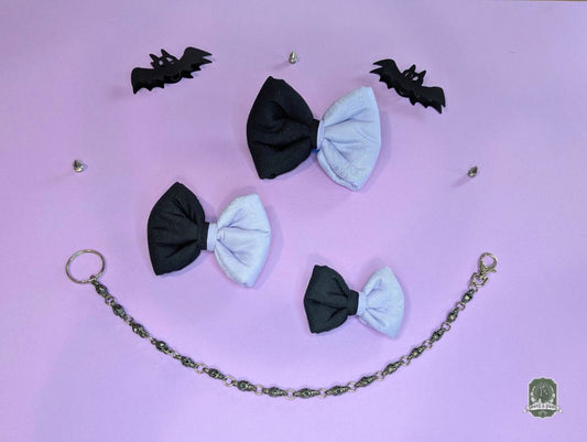 Black and lilac pet bow tie set with a chain on a purple background