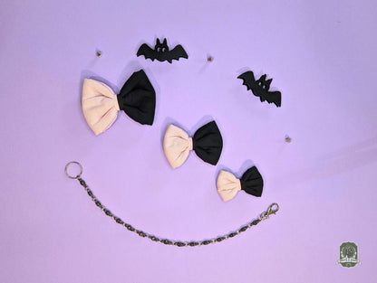 Pet Bow ties and decorative bat shapes on a purple background