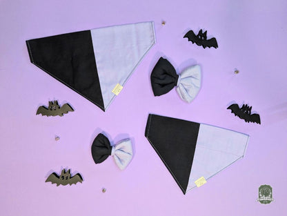 Black and lilac dog bandanas with matching dog bow ties on a purple background with bat shapes.
