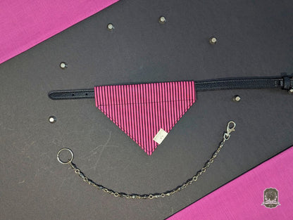 Pink dog bandana on a black collar and chain on a gray and pink background