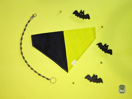 Black slide over the collar bandana with black bat decorations on a yellow background.