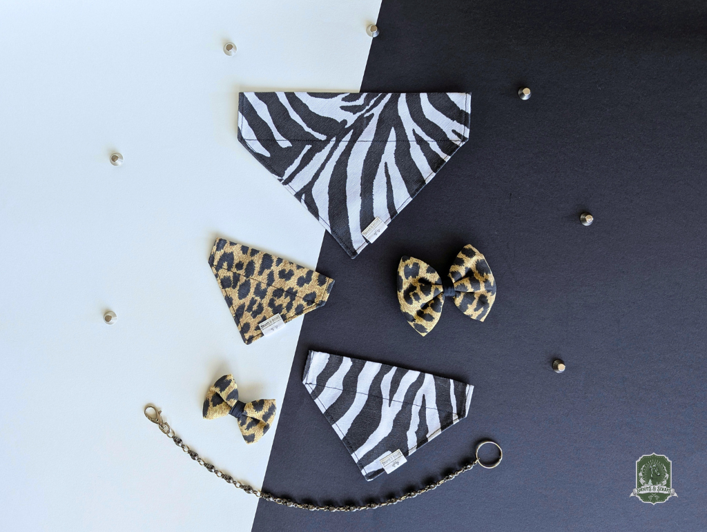 Zebra and leopard print dog accessories on a dark surface with a white background