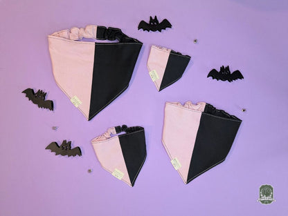 Black and pink dog bandanas with decorative bats on a purple background