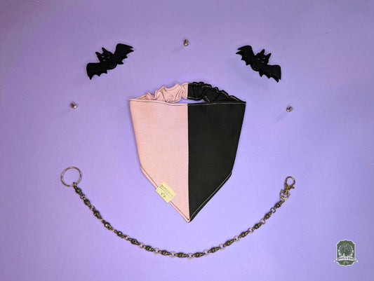 Black and pink dog bandana with elastic collar on a purple background