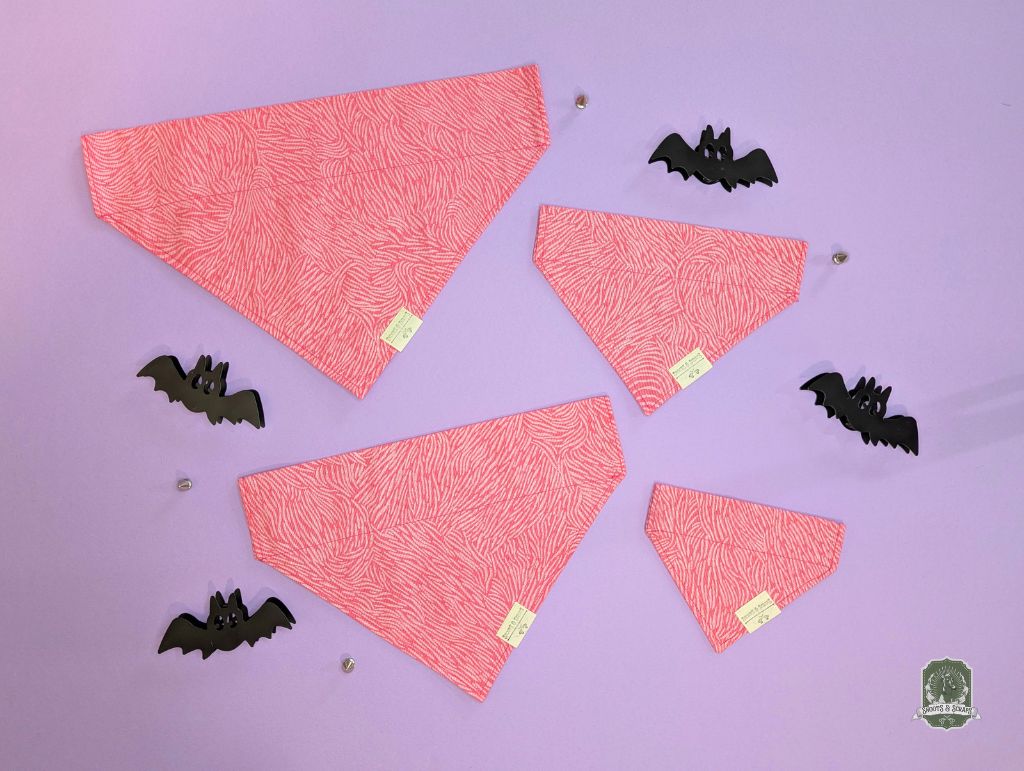Pink zebra print dog bandana set on a purple background